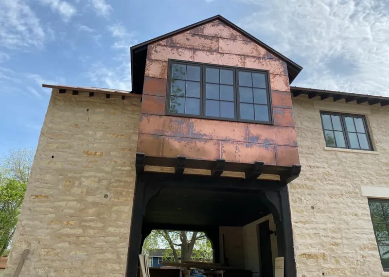 Copper metal panel facade on a stone building for Skylight Installation in Knoxville