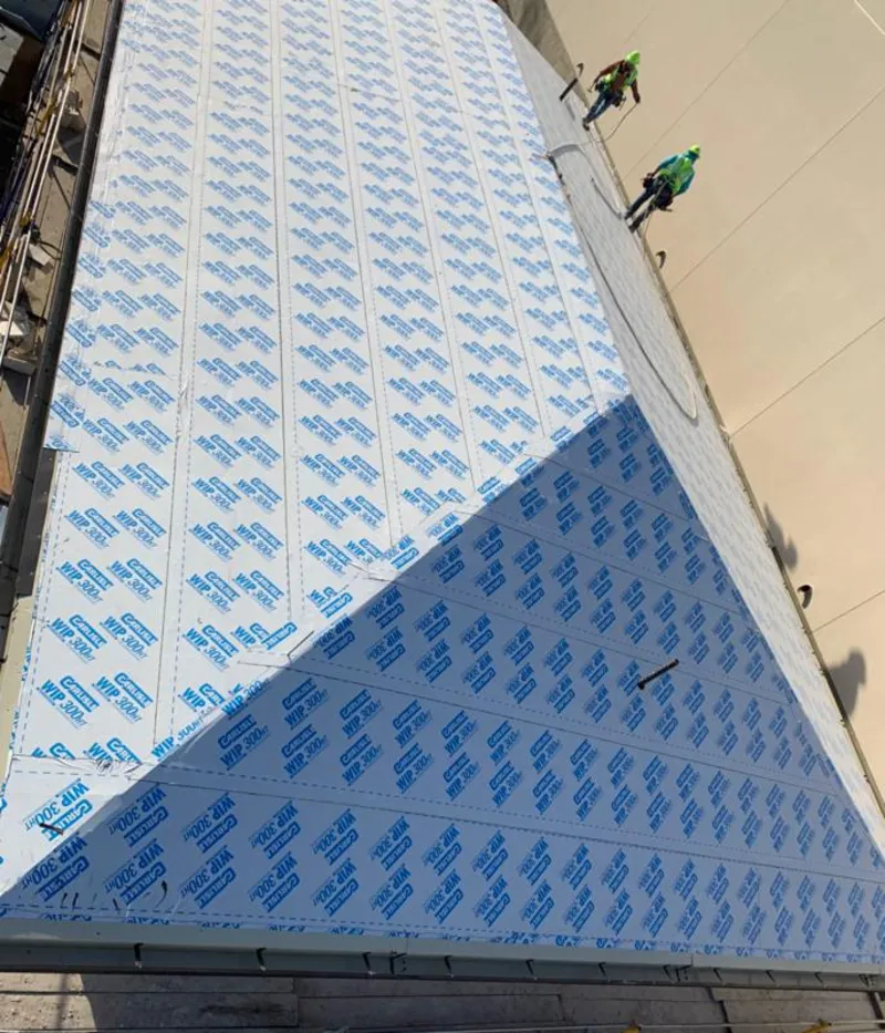 Professional roofers installing underlayment on a metal roof in Knoxville